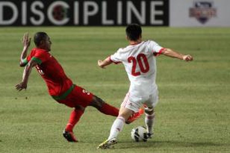 Pemain Indonesia Tinus Pae (kiri) berjibaku dengan pemain China Wu Lei pada babak kualifikasi Piala Asia 2015 di Stadion Utama Gelora Bung Karno, Jakarta, Selasa (15/10/2013). Pertandingan berakhir imbang dengan skor 1-1. Pada laga di China, Jumat (15/11/2013), Wu Lei membobol gawang Indonesia.