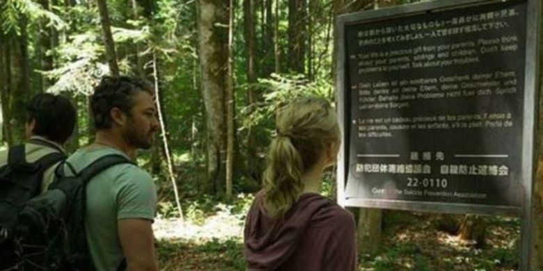 Film The Forest (2016) memperlihatkan plang imbauan tidak bunuh diri di Hutan Aokigahara. (Foto: Gramercy Pictures) 