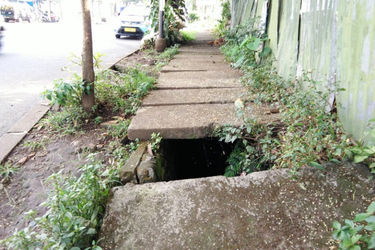 Trotoar bolong di Bandung rawan menimbulkan kecelakaan. Menurut warga sekitar, kerusakan sudah berlangsung setahun namun belum diperbaiki.
