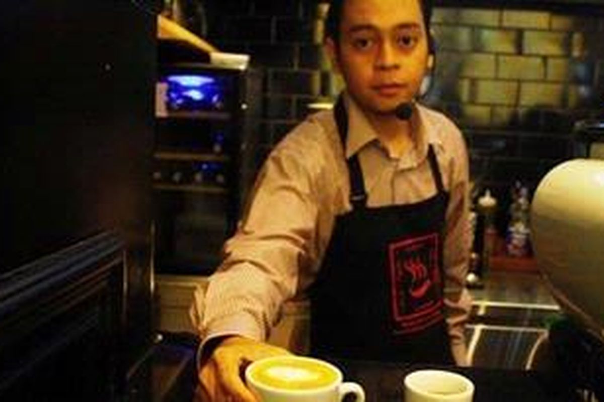 Doddy Samsura, barista asal Yogyakarta, menunjukkan cappucinno kreasinya yang dibuat dari kopi Toraja. 