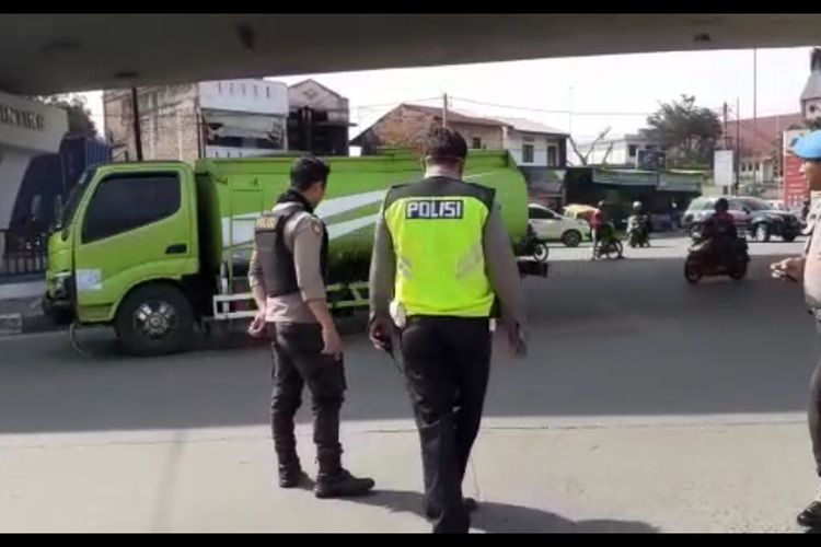 Tangkapan layar merekam tiga orang polisi berdiri di sekitar lokasi jatuhnya seorang pria berjaket dan mengenakan seragam polisi dari atas jembatan layang (fly over) Jalan Jamin Ginting pada Kamis pagi tadi (30/1/2020). Pria tersebut kemudian dibawa dan dirawat di Rumah Sakit Bhayangkara Medan.