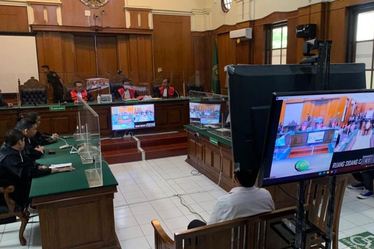 Three police members attend their trial at a courthouse in Surabaya on Thursday, March 16, 2023. Last year's deadly stampede happened during a match in Kanjuruhan Stadium in the East Java city of Malang, where 135 people were killed after police fired tear gas into supporters as they invaded the pitch. 