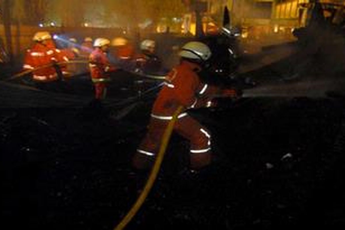  Petugas kebakaran sedang mencoba memadamkan api yang terjadi di  di belakang Plaza Semanggi, tepatnya di Jalan H Musanif, Jakarta, Senin (5/9/2011). Kejadian ini  menghanguskan 30 rumah petak yang ditempati para pemulung dan pengamen