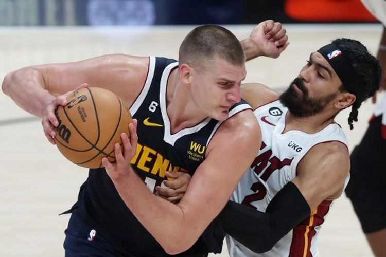 Center Denver Nuggets, Nikola Jokic (kiri), berduel dengan pemain Miami Heat Gabe Vincent (kanan) pada gim 2 final NBA 2023 di Ball Arena, Denver, Colorado, Amerika Serikat, Senin (5/6/2023) dini hari WIB.