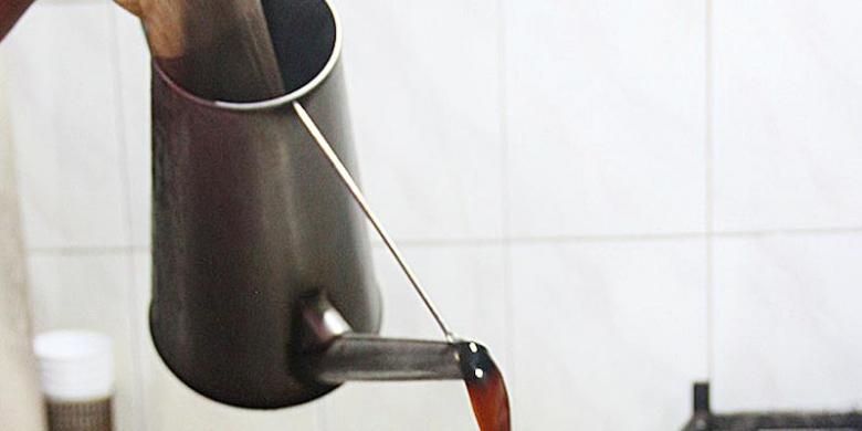 Coffee o or brewed black coffee is poured into the cup.