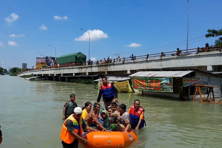 Relawan gabungan mengevakuasi warga Kecamatan Karanganyar yang sebelumnya terjebak banjir dibawa ke posko pengungsian sementara Tanggulangin, Kecamatan Karanganyar, Kabupaten Demak, Jumat (9/2/2024). (KOMPAS.COM/NUR ZAIDI