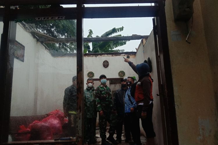 Caption: Sejumlah relawan tengah mengevakuasi rumah korban terdampak angin kencang di kawasan Kecamatan Singosari, Kabupaten Malang.