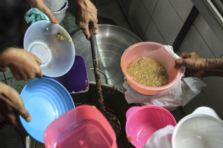 Warga mengantre untuk mendapatkan bubur syuro yang dibagikan secara gratis selama ramadhan di Masjid Al Mahmudiyah Suro atau Suro di Jalan Ki Gede Ing Suro, Kelurahan 30 Ilir, Kecamatan Ilir Barat II, Palembang, Sumatera Selatan.