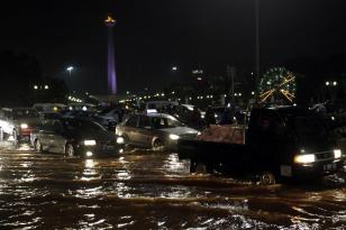 Hujan tiga jam pada Senin (3/2/2014) malam menyebabkan banjir di sekitar Monumen Nasional, Jakarta Pusat.