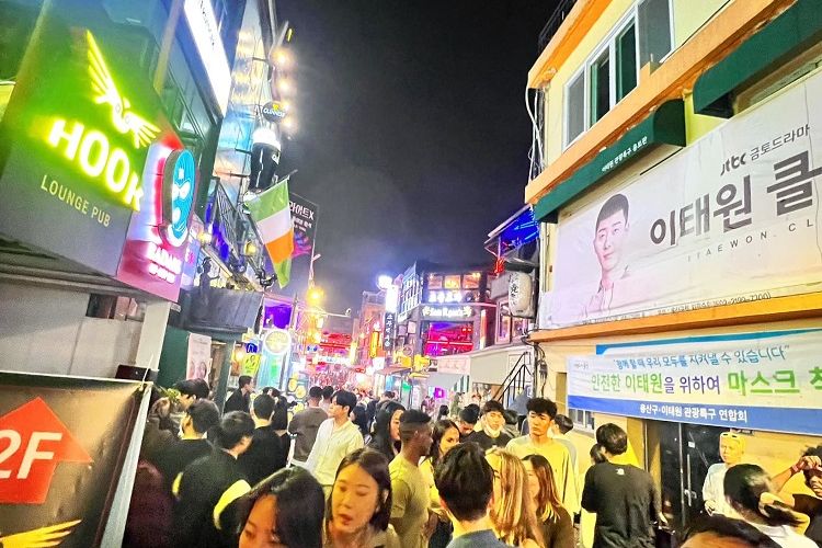 Pengunjung dan turis hilir mudik di tengah sesaknya kerumunan yang melintas di gang sempit di distrik internasional dan dunia malam Seoul di Itaewon, Jumat malam (30/9/2022) pukul 23.47 waktu setempat