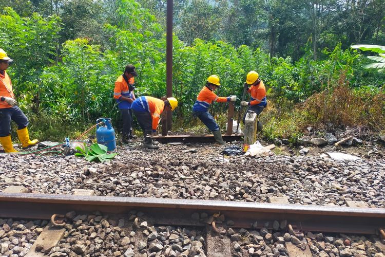 Petugas dari KAI Daops 9 Jember saat memasang palang pintu kereta api guna mencegah kecelakaan 