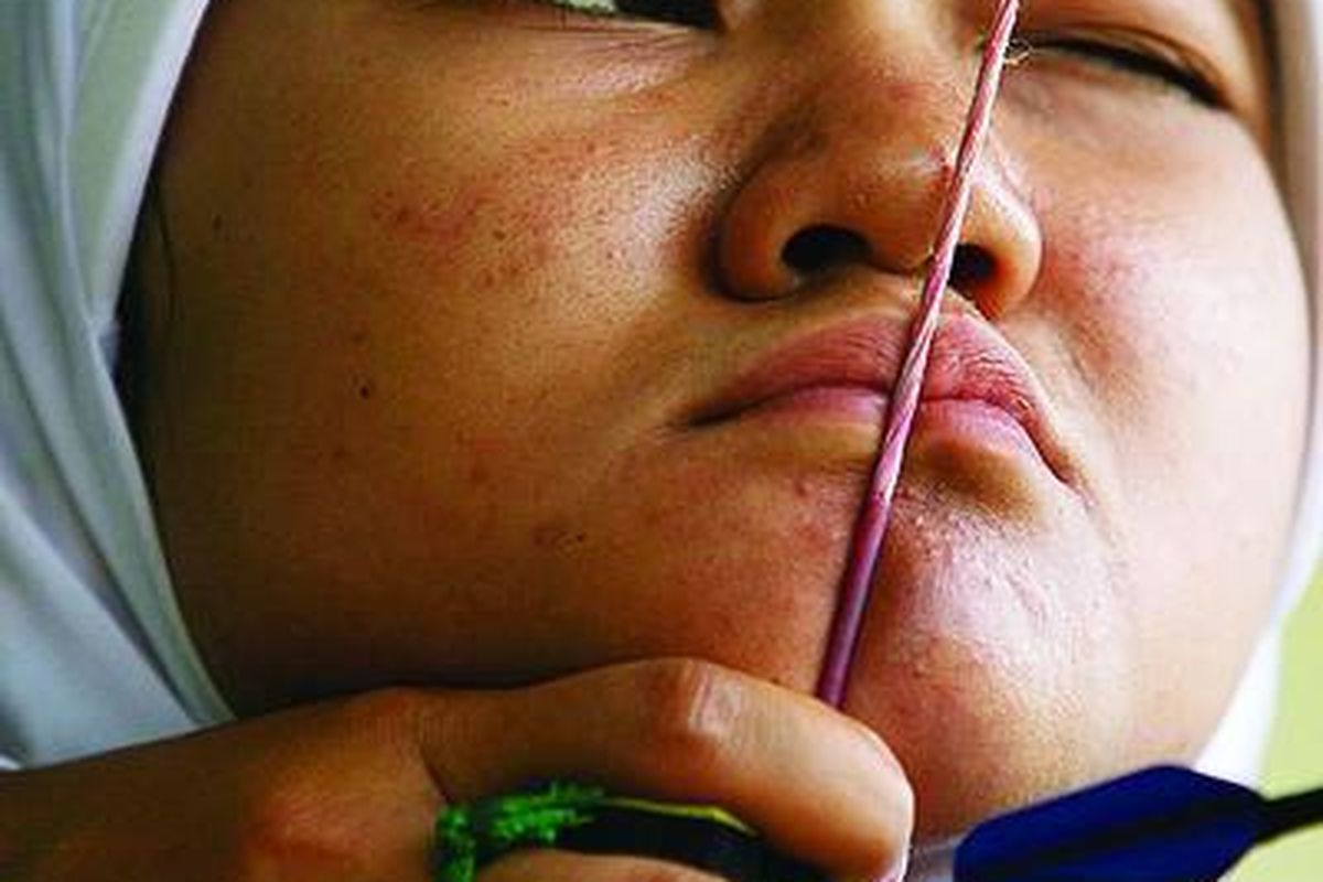 Pemanah pelatnas SEA Games XXVI/2011, Mutia Nur Ulfah, berlatih di lapangan panahan kompleks Gelora Bung Karno, Jakarta, Rabu (13/4).