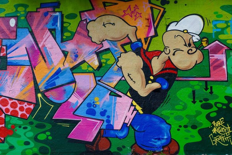 Tokoh kartun Popeye si Pelaut, diabadikan dalam bentuk graffiti di tembok.