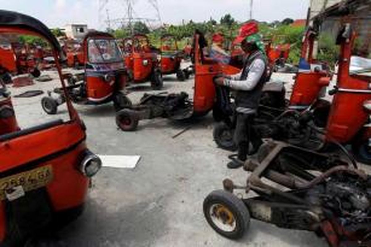 Petugas menghancurkan bajaj di kawasan Pulogebang Indah,  Kelurahan Pelogebang, Kecamatan Cakung, Jakarta Timur, Selasa (7/5/2013). Kurang lebih 100 bajaj dari operator PT Trans Matahari Utama diremajakan menjadi bajaj biru berbahan bakar gas yang lebih nyaman dan lebih ramah lingkungan.