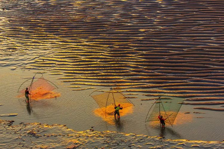Nelayan menebar jala di desa Xiapu, China.