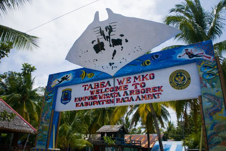 Gapura di pintu masuk Desa Wisata Arborek yang lengkap dengan ikon desa yaitu ikan pari manta, Kabupaten Raja Ampat, Papua Barat, Rabu (27/10/2021).