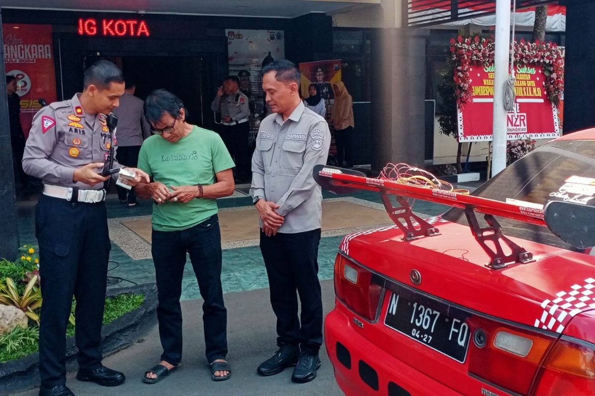 Petugas kepolisian dari Satlantas Polresta Malang Kota menegur pemilik mobil sedan Mazda 323 berwarna merah dengan nomor polisi N 1367 FQ yang menggunakan lampu blitz di belakang sehingga menyilaukan kendaraan lainnya.