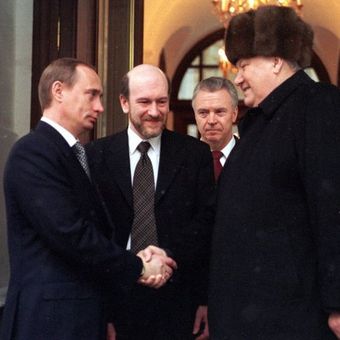 Retiring Russian President Boris Yeltsin shakes hands with Prime Minister Vladimir Putin - his nominee as acting President - as he leaves his office.