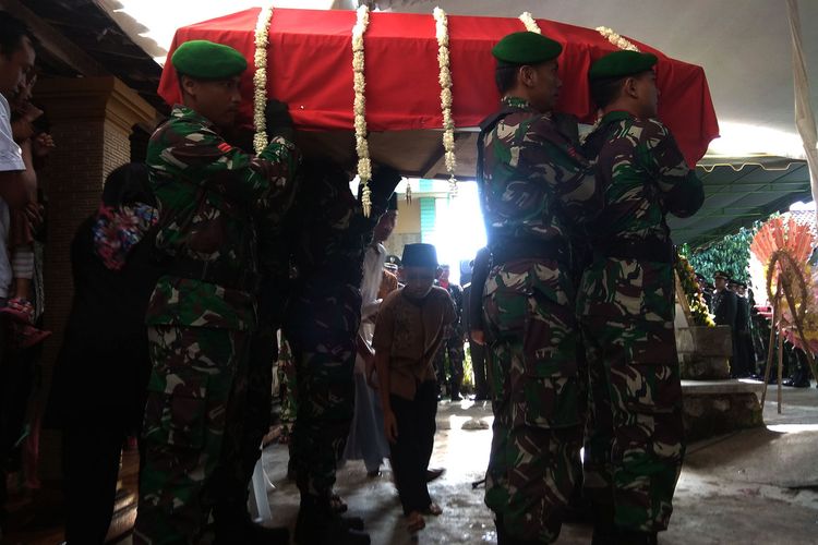 Keluarga almarhum Kopda Anumerta Dwi Purnomo melakukan tradisi brobosan saat pemberangkatan jenazah ke pemakaman umum Desa Banjarpanjang