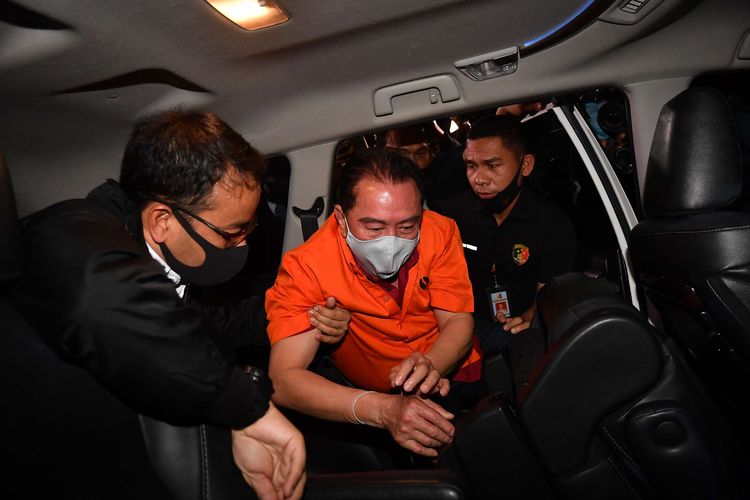 The members of Indonesian police escort a fugitive and graft convict Djoko Tjandra after he arrives at Halim Perdanakusuma Airport in Jakarta on Thursday, July 30.