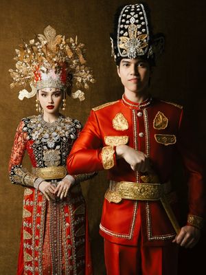 Syifa Hadju dan El Rumi tampil serba merah dalam busana adat Gorontalo saat prewedding. Detail mahkota hingga ornamen emas jadi sorotan.