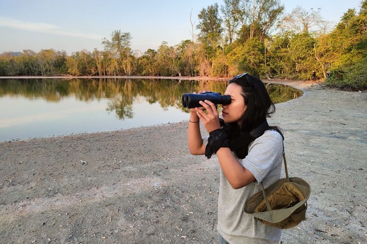 Salah seorang peserta pengamatan burung (birdwatching) menggunakan binokuler mengamati burung di danau kecil di dalam Cagar Alam Panua di Kabupaten Pohuwato. Kegiatan ini dilaksanakan Burung Indonesia bersama sejumlah lembaga dan jurnalis.