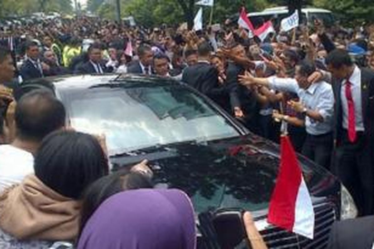 Massa mendekati mobil RI 1 yang ditumpangi Presiden Joko Widodo di Jalan Sudirman, Jakarta Pusat, Senin (20/10/2014). 