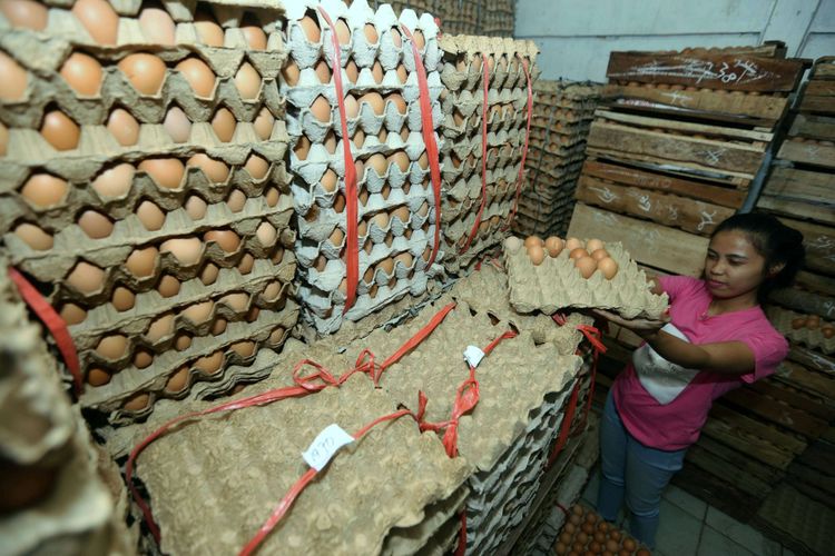 Seorang pedagang telur saat berjualan di Serpong, Tangerang Selatan, Banten, Kamis  (19/7/2018). Akibat tingginya permintaan, harga jual telur ayam ras mencapai hingga Rp 29.000 per kilogram atau untuk harga eceran tembus Rp 2.500 per butir.