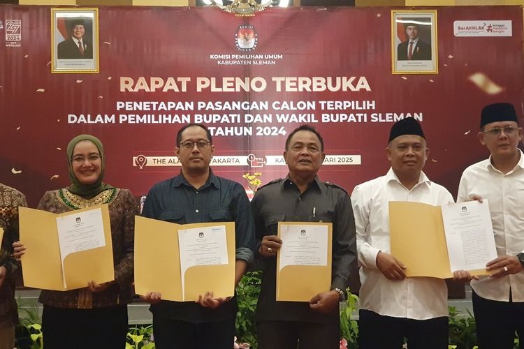 Pasangan Calon bupati dan calon wakil bupati Sleman, Harda Kiswaya - Danang Maharsa (mengenakan kemeja putih dan peci hitam) saat hadir dalam rapat pleno terbuka penetapan pasangan calon terpilih dalam Pilkada 2024. Di dalam rapat pleno ini KPU Sleman secara resmi menetapkan pasangan Harda Kiswaya - Danang Maharsa sebagai calon bupati dan calon wakil bupati terpilih.
