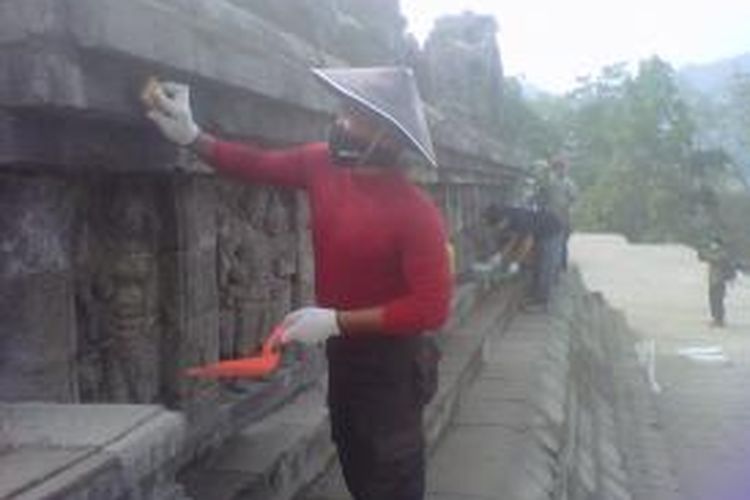 Sejumlah relawan sedang membersihkan abu Gunung Kelud yang menempel di batu-batu candi Borobudur, Magelang, Jawa Tengah, Senin (17/2/2014).