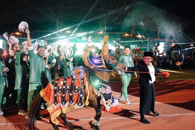 Bupati Lumajang Thoriqul Haq membawa jaran kencak saat parade atlet dalam Pembukaan Porprov Jatim VII di Stadion JSG Jember, Sabtu (25/6/2022)