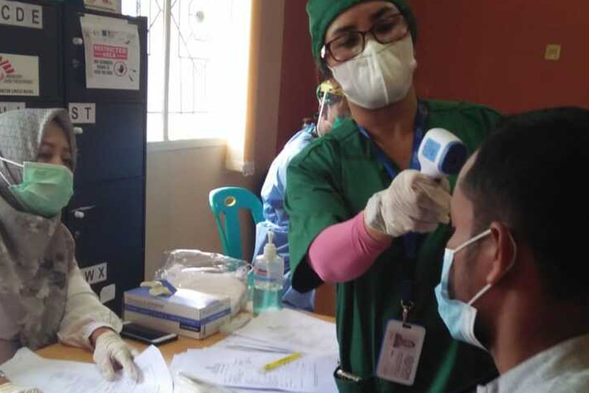 The Rohingya refugees conduct Covid-19 rapid antigen tests in a Lhokseumawe temporary shelter in Aceh province on Wednesday, March 24.  