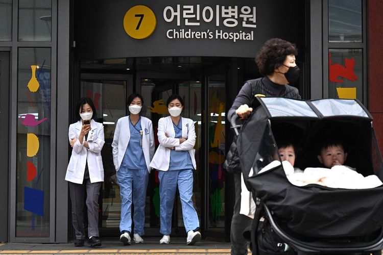 Petugas medis berjalan di luar rumah sakit anak di Seoul, Korea Selatan, pada 11 Maret 2024.
