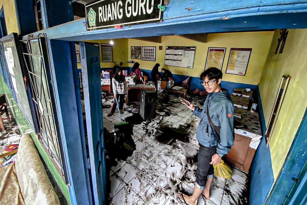 Sejumlah siswa MTs Darussalam, Kota Cimahi membersihkan lumpur sisa banjir yang merendam wilayah Kelurahan Melong, Kota Cimahi, Jawa Barat, Rabu (6/12/2023).