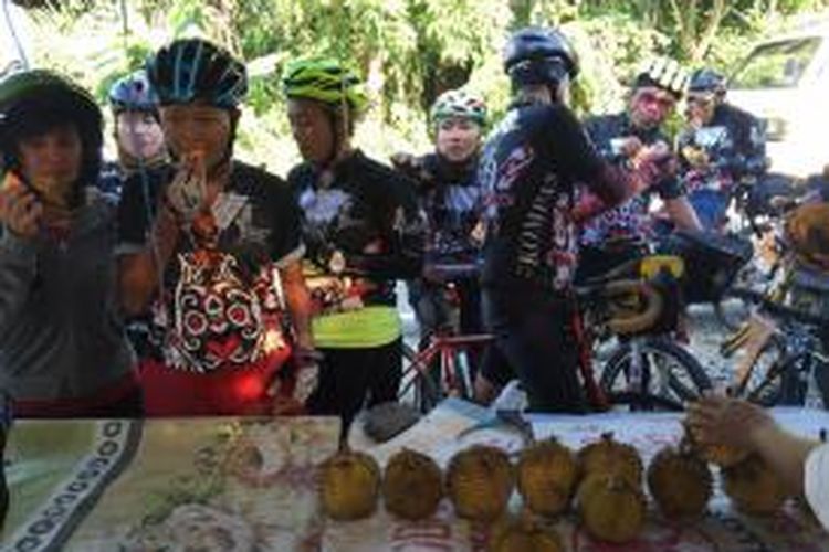 Para peserta Jelajah Sepeda Kompas Banjarmasin mencicipi durian lai sebelum mengakhiri Etape 5 Tanah Grogot-Waru di pinggir Jalan Provinsi, Desa Api-Api, Kecamatan Waru, Kabupaten Penajam Paser Utama, Jumat (8/5/2015).