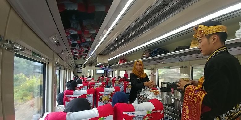 Dua orang petugas kereta api Argo Parahyangan Bandung-Jakarta sedang memberikan layanan restoran pada Sabtu (28/9/2019). PT KAI mengkampanyekan wisata kuliner sebagai bagian dari layanan di dalam kereta.