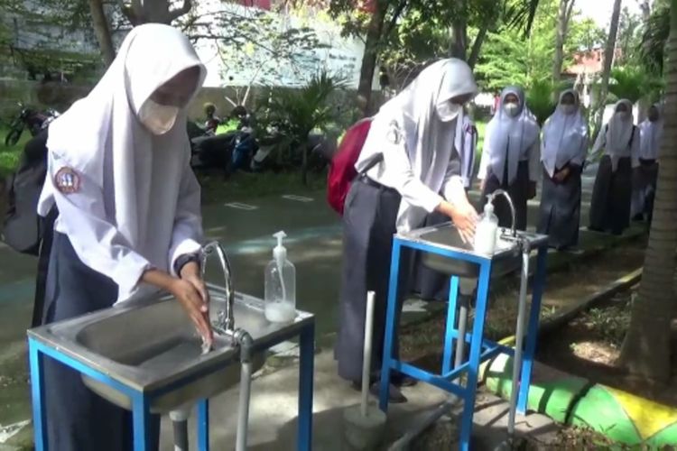 Sekolah Tatap Muka Disambut Antusias, Siswa Antri Cuci Tangan dan Periksa Suhu Tubuh Puluhan Meter di Pintu Gerbang