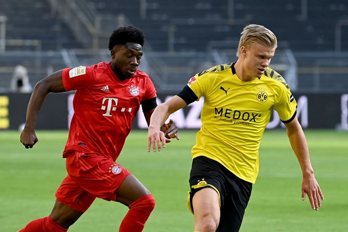 Striker Dortmund Erling Braut Haaland (kanan) dan pemain tengah Bayern Muenchen Alphonso Davies bersaing untuk mendapatkan bola dalam pertandingan Liga Jerman, Borussia Dortmund vs Bayern Muenchen pada 26 Mei 2020 di Dortmund, Jerman.