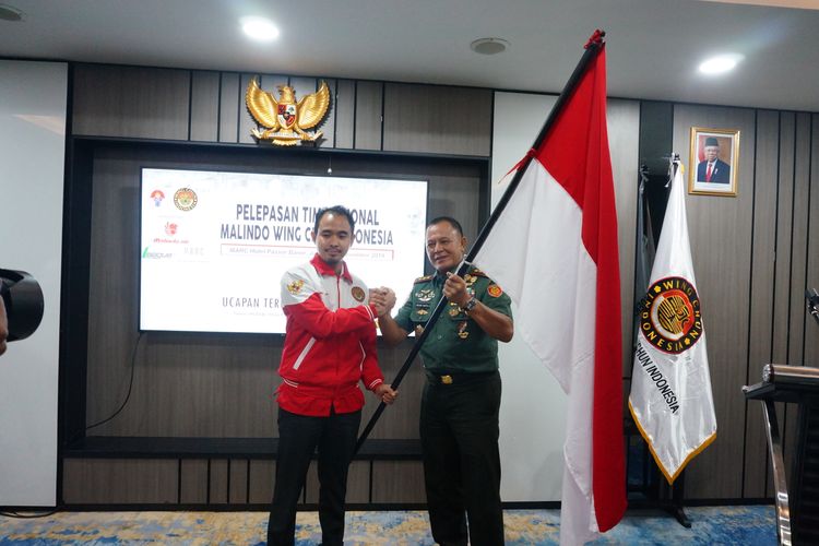 Panglima Komando Cadangan Strategis Angkatan Darat (Pangkostrad), Letjend TNI Besar Harto Karyawan (kanan) menyerahkan bendera Merah Putih kepada manajer timnas Wing Chun Indonesia, Maulana Zaenal (kiri) sebagai simbol pelepasan atlet yang akan mengikuti International Ip Man Ving Tsun Match 2019, Rabu, 13 Novemeber 2019.