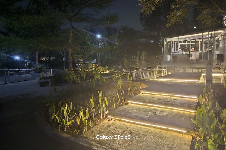 Hasil foto Nightography Samsung Galaxy Z Fold 5. Dalam gambar ini, bisa dilihat lampu-lampu yang berada di bawah tangga akan sedikit diredupkan, supaya obyek di sekitarnya, seperti tanaman, tekstur tangga, dan obyek lainnya bisa dilihat dengan jelas.