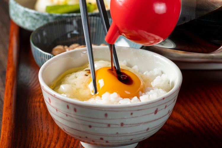 Ilustrasi tamago kake gohan khas Jepang. Terdiri dari nasi panas, telur mentah, dan kecap asin. 