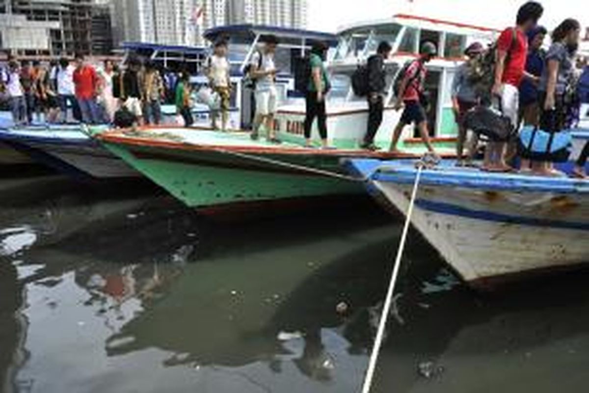 Wisatawan yang selesai berlibur di Kepulauan Seribu turun dari kapal yang bersandar di Dermaga Muara Angke, Jakarta, Minggu (6/1/2013). 