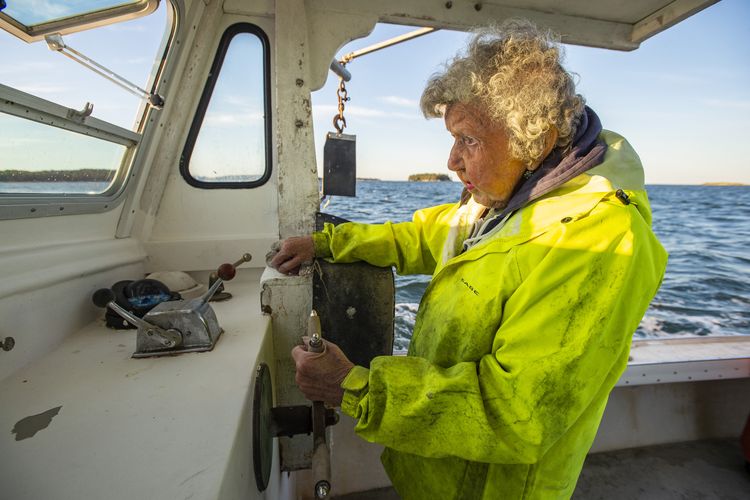 Virginia Oliver, 101, pilots her boat Virginia named after her, to head out to haul in her and her sons lobster traps in Penobscot Bay in Maine on July 31, 2021. - Virginia Oliver has been catching lobsters off the coast of Maine since age 7 and is now 101 -- and still going strong.
She is the oldest licensed lobsterwoman in the northeastern state, and local historians describe as perhaps the oldest active one in the world.
Oliver goes out into the waters off Rockland three days a week with her 78 year old son Max, who helps her crew the boat, aptly named by her husband, now passed, after her. (Photo by Joseph Prezioso / AFP)