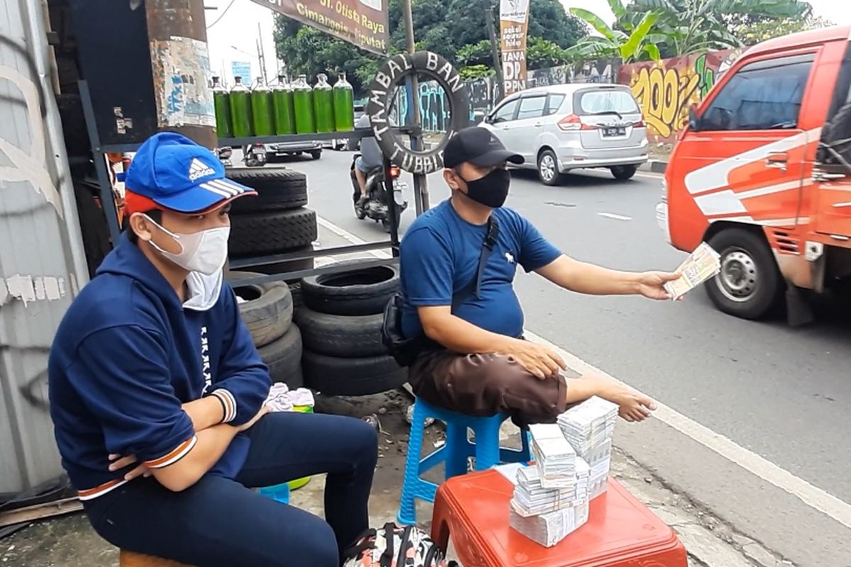 Penjual jasa penukaran uang menunggu pembeli di kawasan Jalan Otista Raya, Ciputat, Tangerang Selatan, Selasa (4/6/2021).