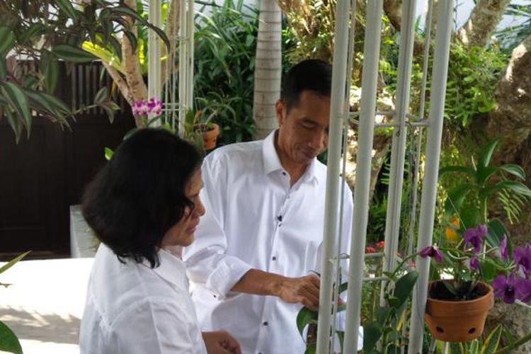 Joko Widodo dan Iriana mengurus anggrek di halaman belakang rumahnya di Solo, Jawa Tengah.

