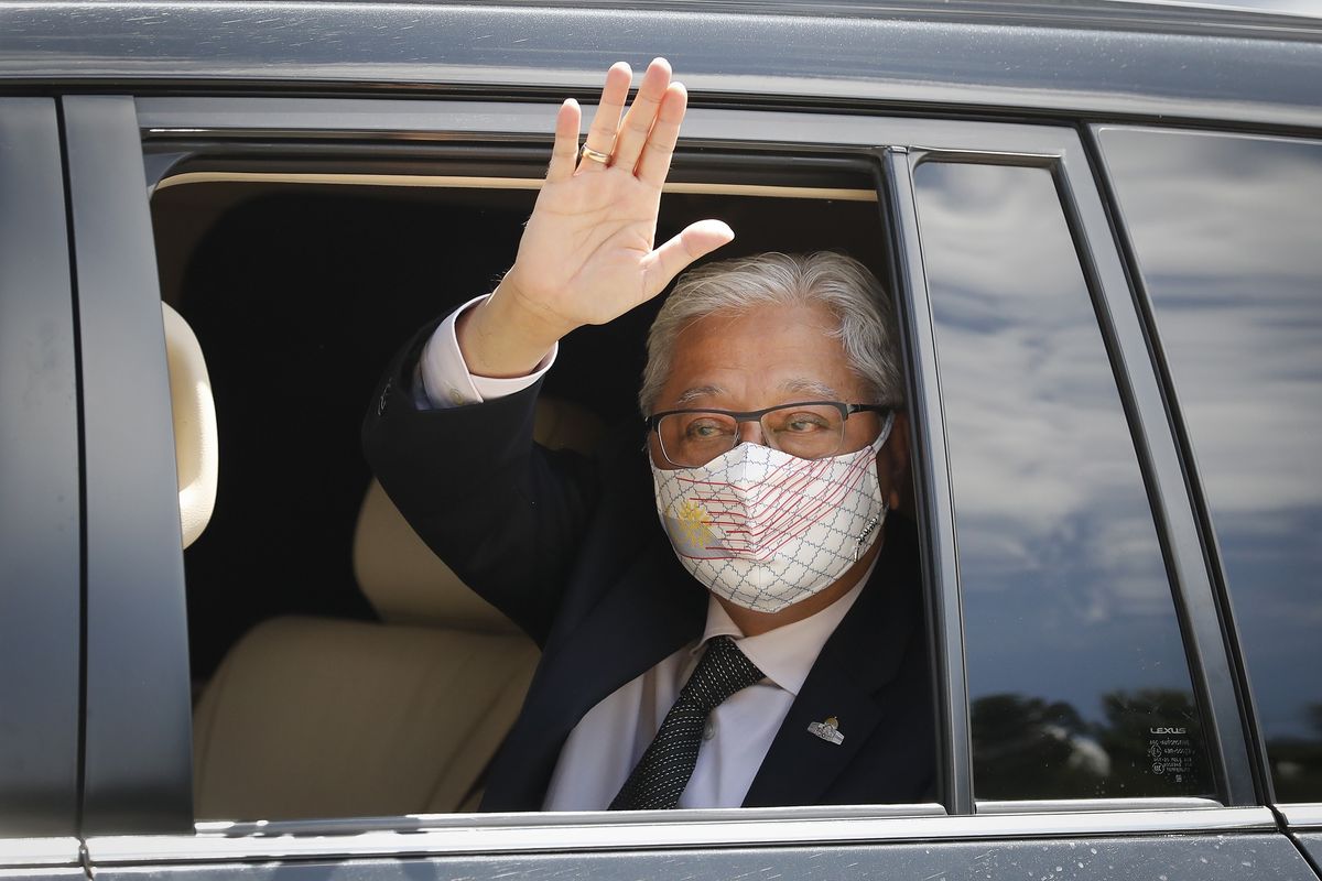 Former Deputy Prime Minister Ismail Sabri Yaakob waves to media as he leaves after meeting with the King at national palace in Kuala Lumpur, Malaysia, Thursday, Aug. 19, 2021. Yaakob appeared to have won majority support to be Malaysia's new leader. His backers have been summoned to the palace Thursday to verify to the king they support him. (AP Photo/FL Wong)