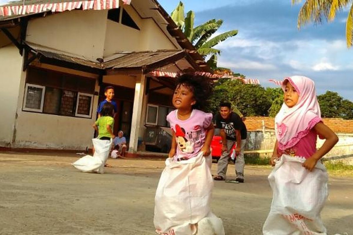 Anak-anak di pengungsian Transito mengikuti lomba balap karung, Selasa (16/8/2016). 