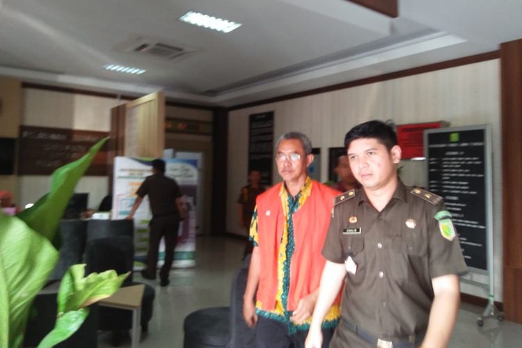 Mantan Sekretaris Dinas Peternakan dan Perikanan Kabupaten Blora, Karsimin saat hendak digelandang menuju mobil tahanan di Kejati Jateng, Kamis (31/10/2019).