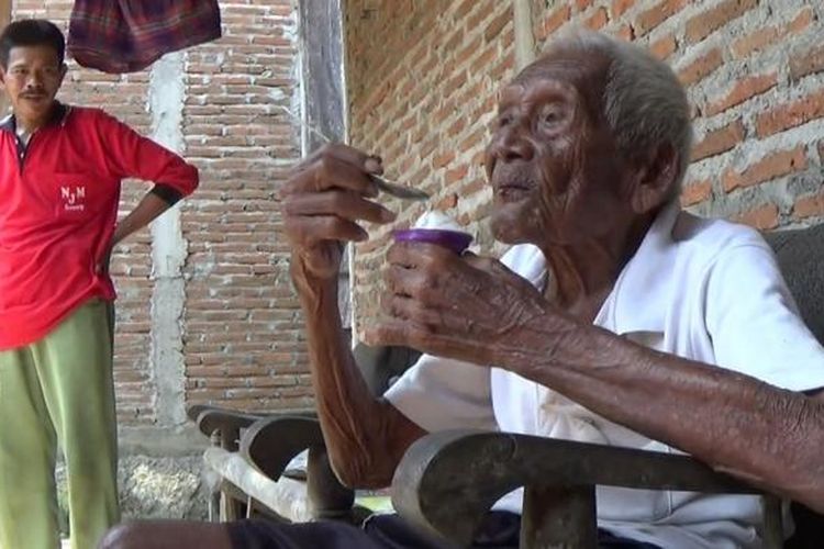 Suparman Sodimedjo atau Mbah Gotho tengah memakan es krim di rumahnya di Klaten, Jawa Tengah, Senin (29/8/2016).