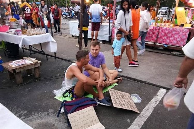 Dua orang turis mengemis di Pasar Samkong, Phuket, Thailand. 